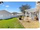 Well-maintained backyard offers a private space with beautiful landscaping at 2116 Baldwin Run, The Villages, FL 32162