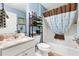 Bathroom with white vanity, granite countertop, a mirror, and bathtub with shower at 2116 Baldwin Run, The Villages, FL 32162