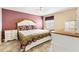 Cozy bedroom featuring a decorative quilt, ceiling fan and neutral tile flooring at 2116 Baldwin Run, The Villages, FL 32162