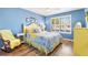 Bright bedroom featuring blue walls, hardwood floors, a ceiling fan, and a large window at 2116 Baldwin Run, The Villages, FL 32162