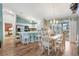 Bright dining area with an adjacent kitchen, stainless steel appliances, and easy access to the outdoor patio at 2116 Baldwin Run, The Villages, FL 32162