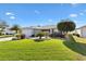 Charming single-story home boasting a well-manicured lawn and beautiful landscaping for enhanced curb appeal at 2116 Baldwin Run, The Villages, FL 32162