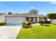 Charming single-story home with a well-manicured lawn and a two-car garage at 2116 Baldwin Run, The Villages, FL 32162