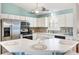 Bright eat-in kitchen with white cabinetry, stainless steel appliances and modern countertops at 2116 Baldwin Run, The Villages, FL 32162