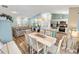Open concept living room and dining area features modern furnishings, vaulted ceilings and natural light at 2116 Baldwin Run, The Villages, FL 32162