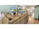 Inviting living room with an electric fireplace, open to the kitchen and dining area at 2116 Baldwin Run, The Villages, FL 32162