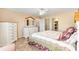 Spacious main bedroom features an ensuite bath, walk-in closet, neutral paint and ceiling fan at 2116 Baldwin Run, The Villages, FL 32162