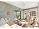 Sunroom with tile floors, lots of windows and ceiling fan overlooking fenced in backyard at 2116 Baldwin Run, The Villages, FL 32162