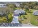 Aerial view of the home featuring a long driveway and mature trees at 21902 King Henry Ave, Leesburg, FL 34748