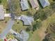 An aerial view of a home with a light gray roof and mature trees, offering a sense of privacy at 21902 King Henry Ave, Leesburg, FL 34748
