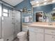 Bathroom features a shower with glass door, single sink, and toilet with nautical decor at 21902 King Henry Ave, Leesburg, FL 34748