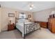 Bedroom showcasing an iron bed, two nightstands with lamps, and a dresser at 21902 King Henry Ave, Leesburg, FL 34748
