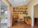 Home office with hardwood floors, vaulted ceiling, natural light, built-in shelving, and traditional decor at 21902 King Henry Ave, Leesburg, FL 34748
