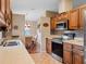 Traditional kitchen with wood cabinets, granite countertops, stainless appliances, tile backsplash, and breakfast nook at 21902 King Henry Ave, Leesburg, FL 34748