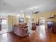 Spacious living room featuring hardwood floors, ample seating, and natural light, creating a welcoming atmosphere at 21902 King Henry Ave, Leesburg, FL 34748