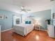 Bedroom with blue walls, white furniture, and wood floors at 2195 Marlboro St, The Villages, FL 32162