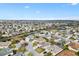 Wide aerial view showcasing neighborhood, houses, and community landscaping at 2197 Derringer Ave, The Villages, FL 32162