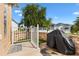 This back patio has a small fenced in area with a grill at 2197 Derringer Ave, The Villages, FL 32162