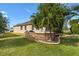 View of the back yard with a grill and small patio area at 2197 Derringer Ave, The Villages, FL 32162