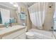 This bathroom features a shower-tub combo and a granite vanity sink at 2197 Derringer Ave, The Villages, FL 32162
