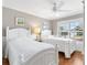 Cozy bedroom features hardwood floors, bright natural light, and two twin beds with white bedding at 2197 Derringer Ave, The Villages, FL 32162