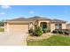 Charming single-story home featuring a well-maintained front yard and attached two-car garage at 2197 Derringer Ave, The Villages, FL 32162