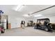 Spacious garage with painted floors and an electric golf cart at 2197 Derringer Ave, The Villages, FL 32162