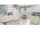 Modern kitchen with white cabinetry, stone countertops, and bright breakfast nook at 2197 Derringer Ave, The Villages, FL 32162