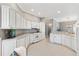 Spacious kitchen featuring white cabinets, updated appliances, and tile flooring at 2197 Derringer Ave, The Villages, FL 32162