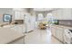 Well-lit kitchen featuring white cabinets, an eat-in dining area, and modern appliances at 2197 Derringer Ave, The Villages, FL 32162