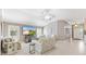 Bright living room with vaulted ceilings, tile flooring, and a large flat screen television for entertainment at 2197 Derringer Ave, The Villages, FL 32162
