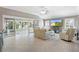 Open-concept living room with tile flooring and sliding glass doors at 2197 Derringer Ave, The Villages, FL 32162
