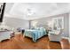 Spacious main bedroom features hardwood floors, tray ceiling, and a cozy sitting area by the window at 2197 Derringer Ave, The Villages, FL 32162
