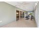 The sunroom is bright with tile floors and leads to the dining room at 2197 Derringer Ave, The Villages, FL 32162