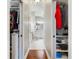 Long hallway leading to the bathroom with walk-in closets providing ample storage on either side at 2197 Derringer Ave, The Villages, FL 32162