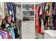 Organized walk-in closet featuring built-in shelving, drawers, and hanging rods for efficient storage at 2197 Derringer Ave, The Villages, FL 32162