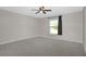 Bright bedroom with carpet flooring, ceiling fan, and a window at 22325 Sw Nectarine Ln, Dunnellon, FL 34431