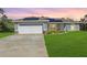 Charming single-story home with a well-manicured lawn, solar panels and a two-car garage at 22325 Sw Nectarine Ln, Dunnellon, FL 34431