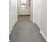 Hallway with carpet flooring leading to bathroom with a white vanity at 22325 Sw Nectarine Ln, Dunnellon, FL 34431