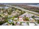 Aerial view of the home's location surrounded by roads, a lake, and nearby businesses at 2714 Vindale Rd, Tavares, FL 32778