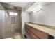 Well-lit bathroom featuring a modern vanity, stylish tile in the shower, and contemporary fixtures, offering a luxurious feel at 2714 Vindale Rd, Tavares, FL 32778