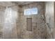 Bathroom boasts tiled walls, window providing natural light, and sleek shower fixtures at 2714 Vindale Rd, Tavares, FL 32778