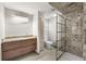 Stylish bathroom with a modern vanity, patterned tile in the shower, and sleek fixtures, providing a spa-like experience at 2714 Vindale Rd, Tavares, FL 32778