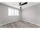 Cozy bedroom with a ceiling fan and a view from a large window at 2714 Vindale Rd, Tavares, FL 32778