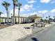 Exterior shot of the community clubhouse featuring palm trees and well-maintained landscaping at 2714 Vindale Rd, Tavares, FL 32778