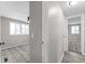 Hallway with modern gray paint, connecting to a bedroom with a ceiling fan and neutral carpet at 2714 Vindale Rd, Tavares, FL 32778