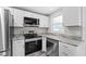 Updated kitchen boasting stainless steel appliances and white shaker cabinets at 2714 Vindale Rd, Tavares, FL 32778