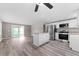 Open-concept kitchen with an island, stainless steel appliances, and a seamless transition to the living area at 2714 Vindale Rd, Tavares, FL 32778