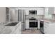Kitchen features stainless steel appliances, granite counters and white shaker cabinets at 2714 Vindale Rd, Tavares, FL 32778