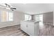 Modern kitchen island with white cabinetry, granite countertops, stainless steel faucet and views to the backyard at 2714 Vindale Rd, Tavares, FL 32778
